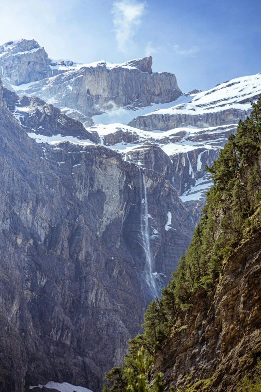 a snowy mountain range with very large cliffs