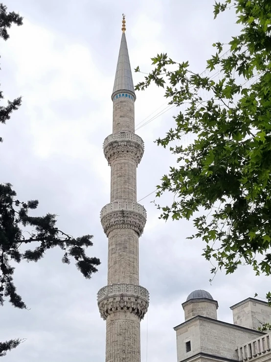 a large white and blue stone monument with a tower in front of it