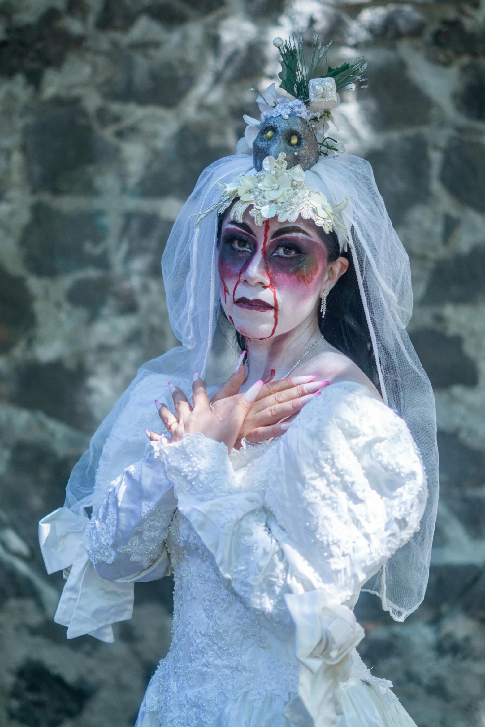 a woman in zombie makeup with flowers and veil