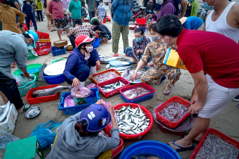 a group of people with lots of containers