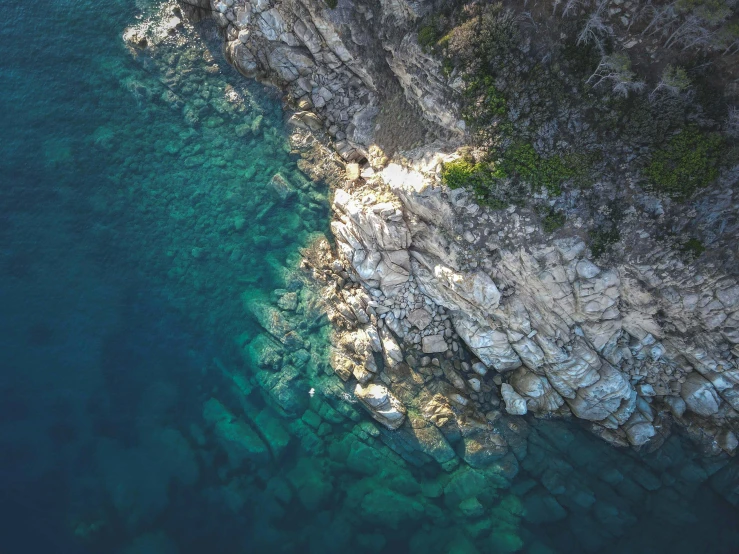 an aerial s of a beach and rock formation