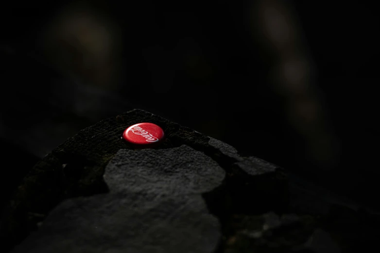 a red frisbee is shown on a black surface