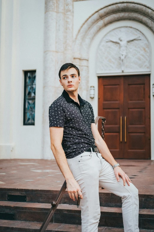 a young man with his cane, leaning on the steps