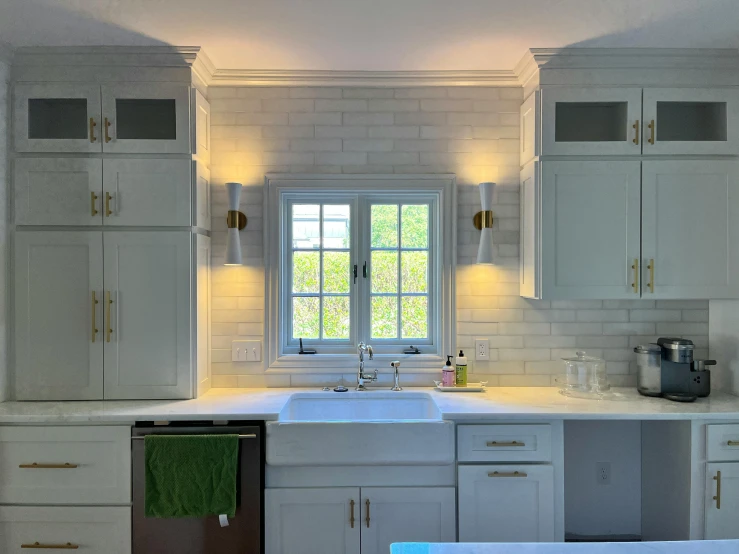 there is a kitchen with all white cupboards and a sink