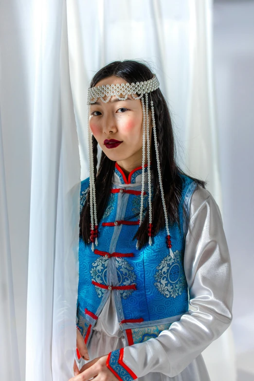 a  dressed in a han nationality poses for a portrait