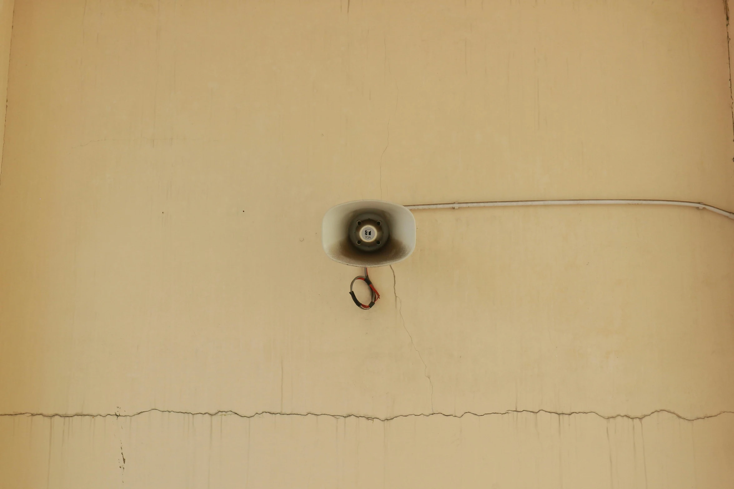 a wall with wires and a ring attached to it