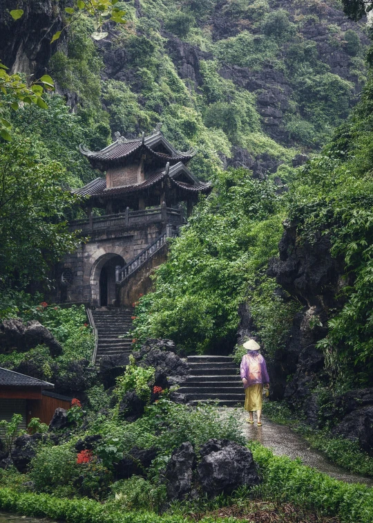 a person walking up a steep hill by a bridge