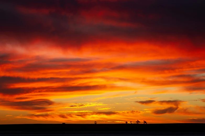 a colorful sky at sunset with several clouds