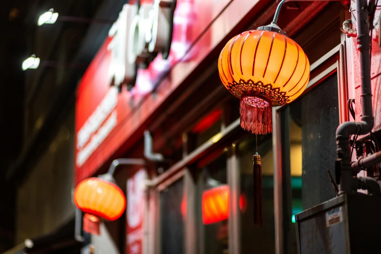 a chinese style lighting is lit up outside of a restaurant