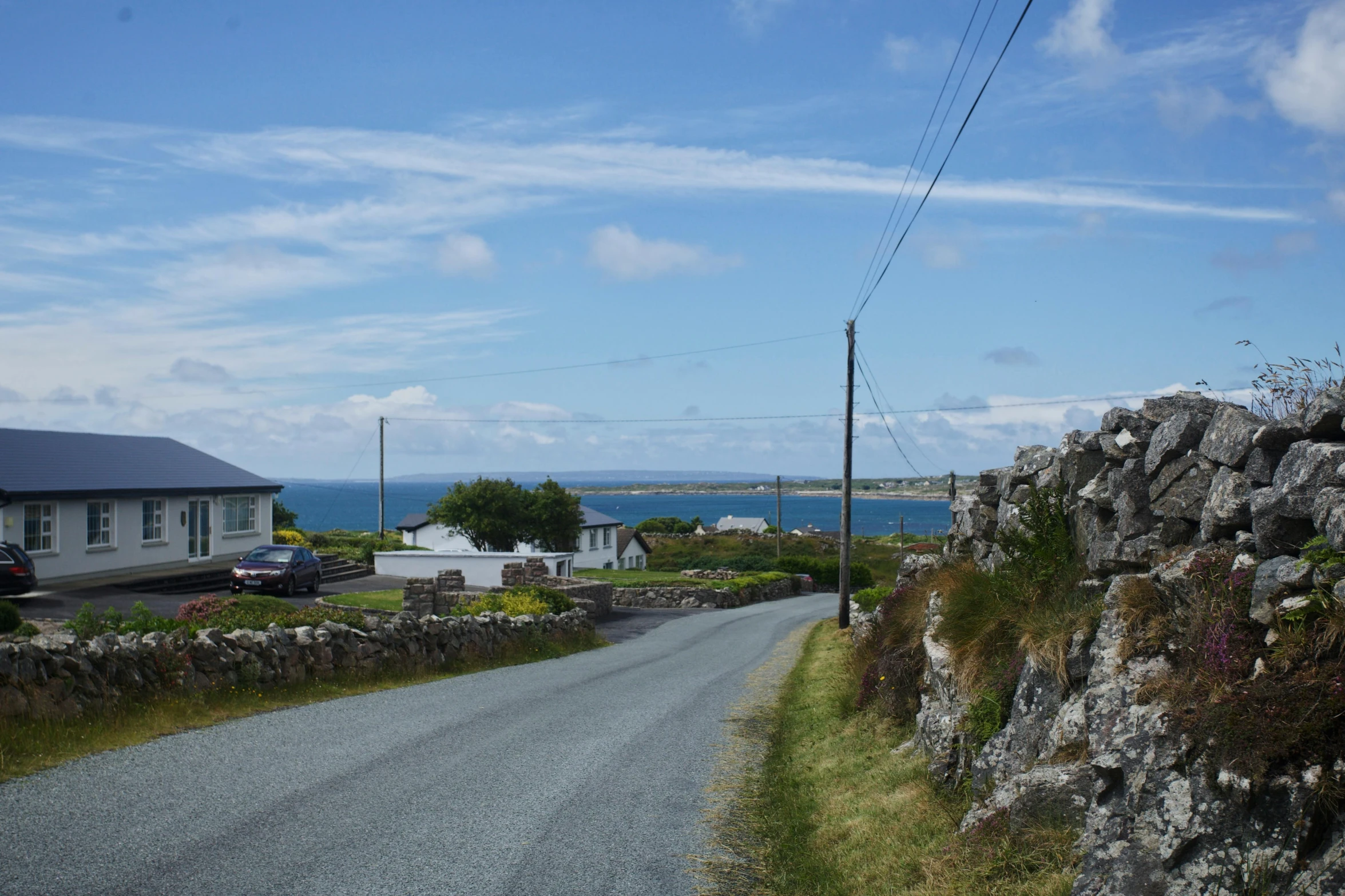 a gravel road is going down a rock wall