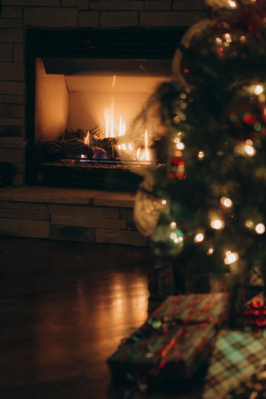 christmas tree and presents in front of a fire place