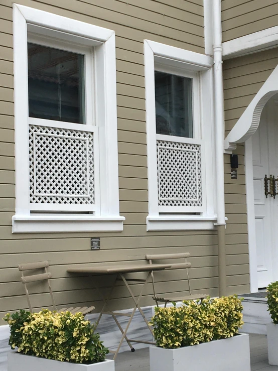 a house with planters and three large flowerpots