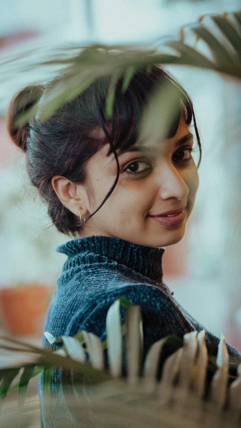 young woman standing with her head looking out into the distance