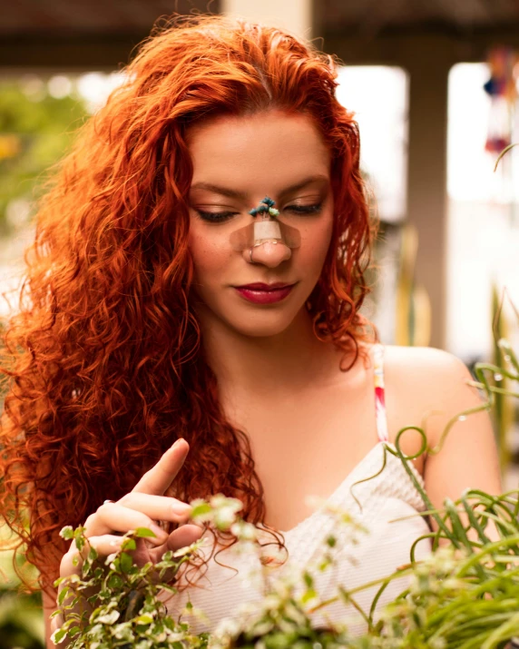 a woman looking down at soing that is growing out of her face