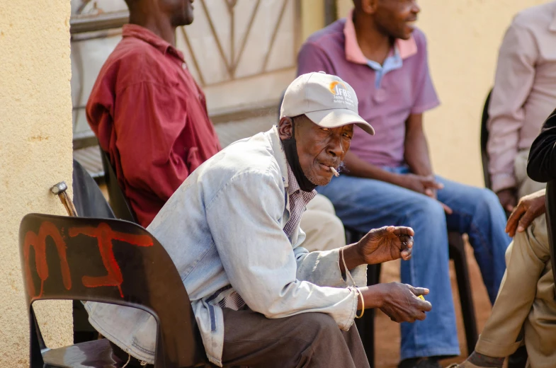 a man is sitting in a chair smoking