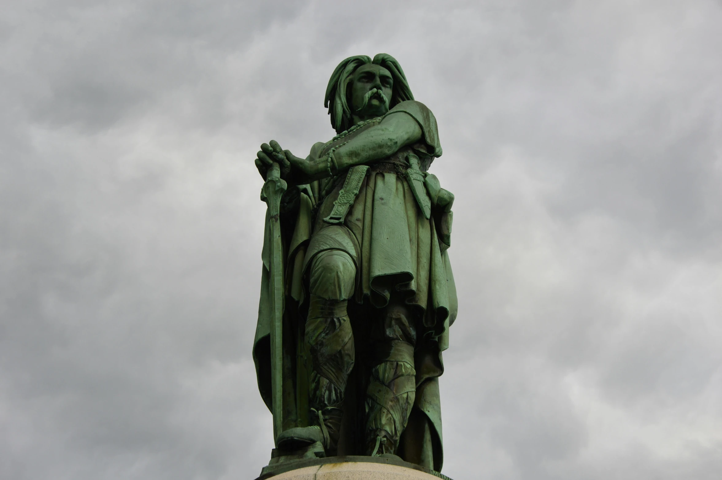 a statue of a person sitting on top of a pedestal