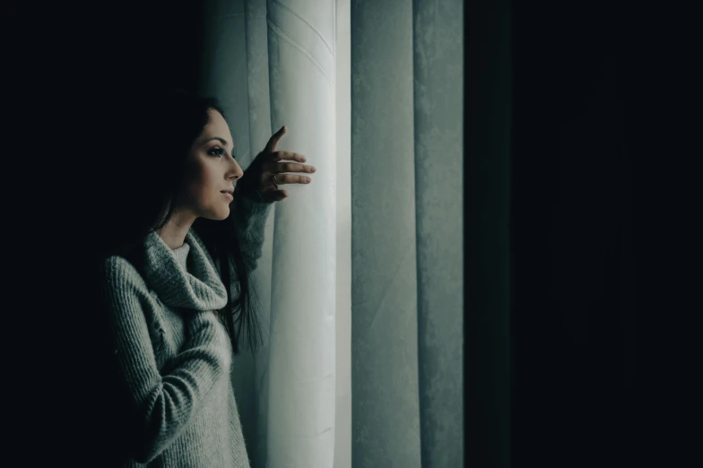 a woman looking out of a window