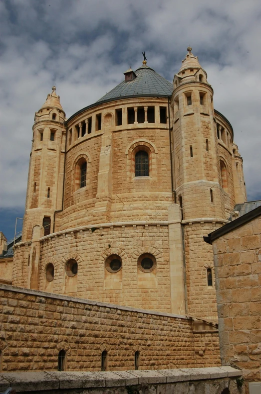 the large cathedral building has arched windows and a gray roof