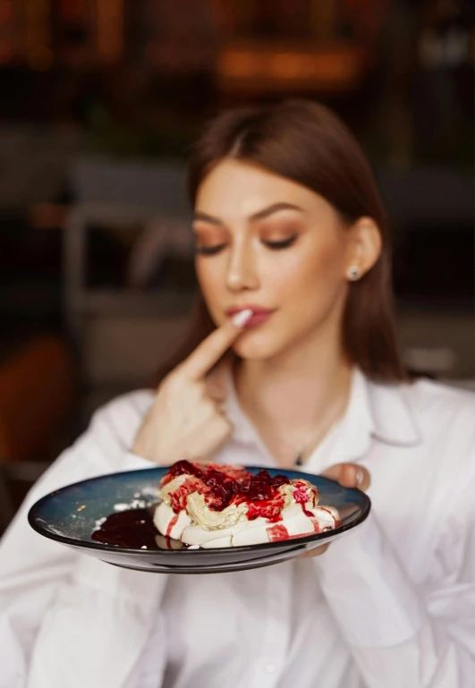 a woman looks as she sees a piece of cake