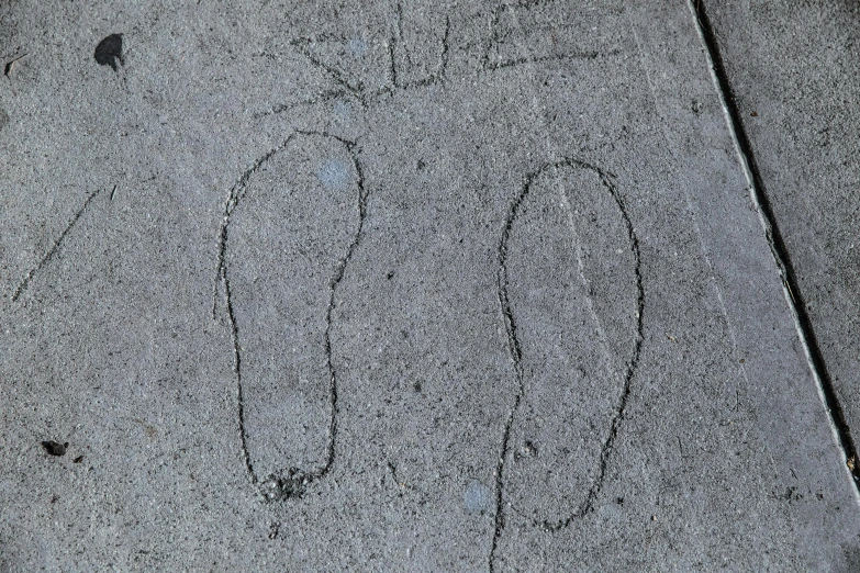 a sidewalk with an arrow drawn on it