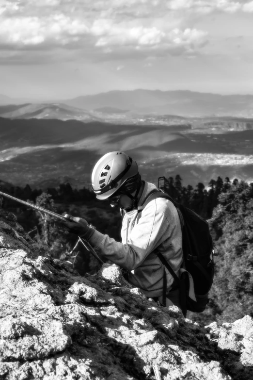 a person sitting at the top of a mountain