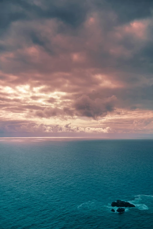 a large body of water under a cloudy sky