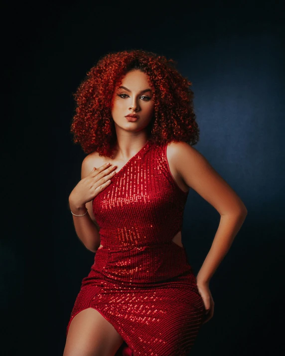 a woman wearing a red sequined dress posing with one hand on her chest