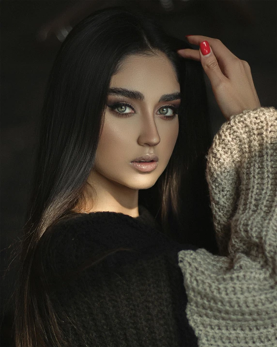 the young woman is wearing a sweater and fingernails
