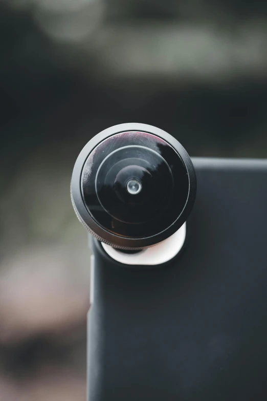 a small black camera on a black phone