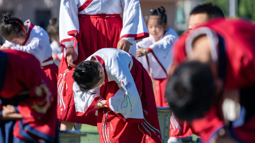 a group of young people wearing uniforms and holding hands on their knees