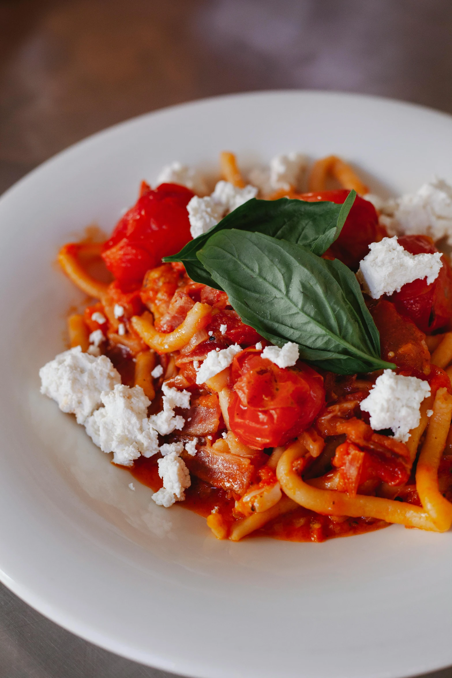 some fettuccine and tomato sauce on a white plate