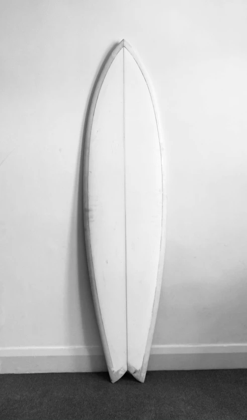 a surfboard is sitting in front of the wall