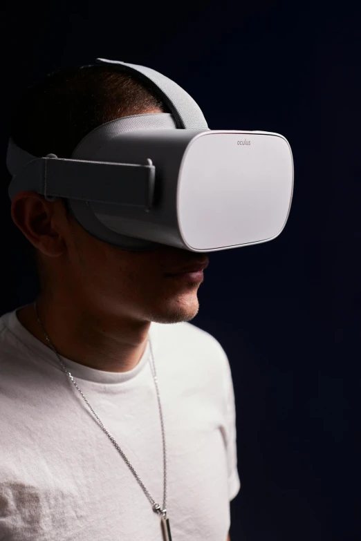 a man wearing a virtual reality headset with a white t - shirt on