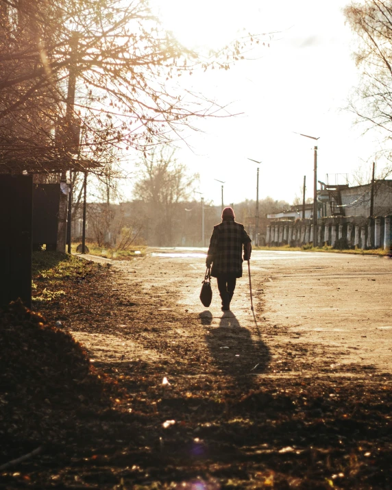 a person walking down a street holding onto soing