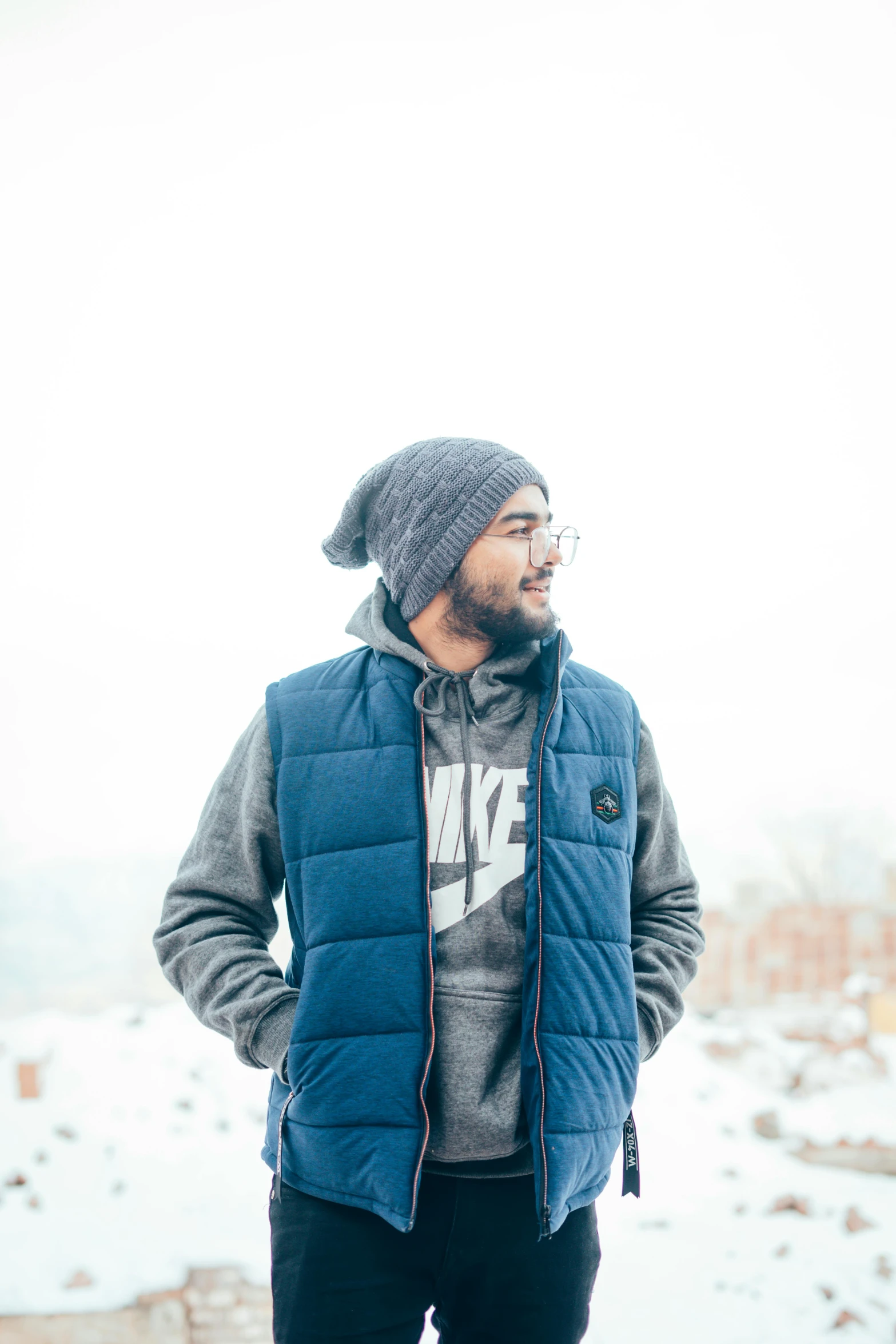 a man standing in front of snow covered mountains