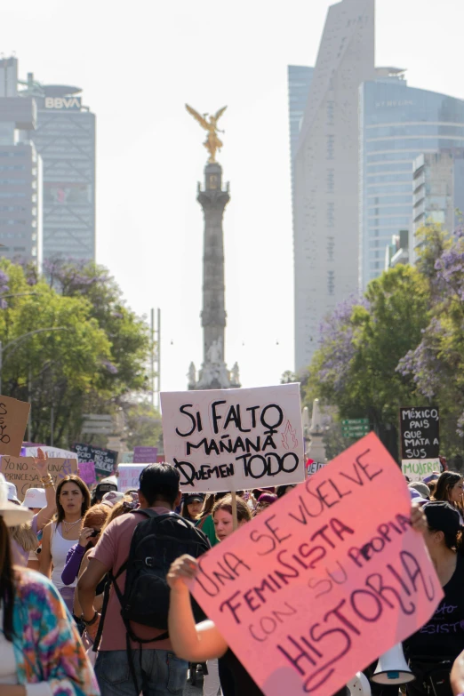 a group of protesters holding signs in the street