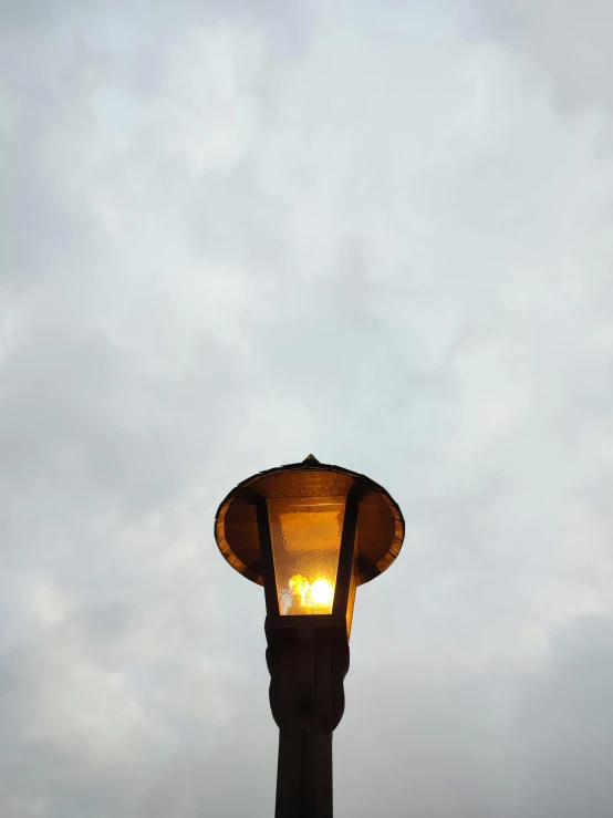 street lamp with no shade against dark sky