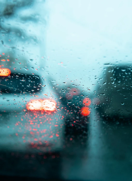 two street lights in rain seen from a windshield