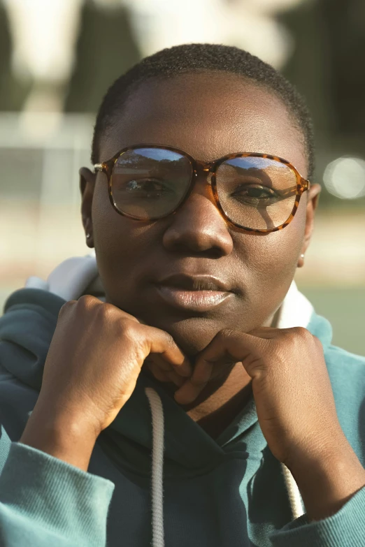 a black woman in glasses with a serious look on her face