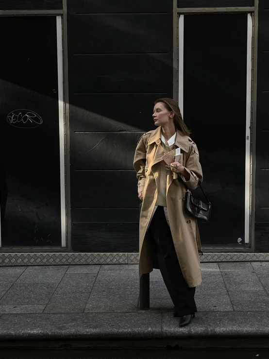 a woman walking down a sidewalk in front of a building