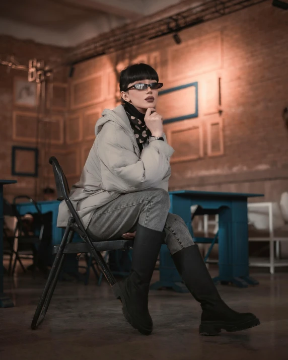 a woman sitting on a chair in a room