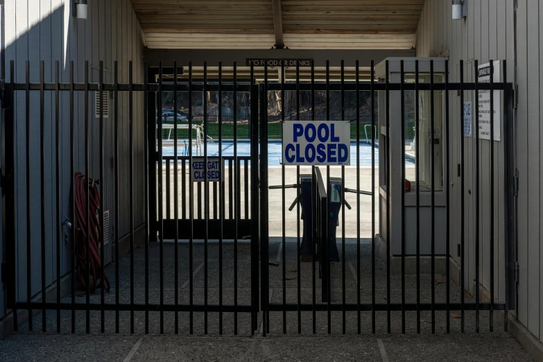 an entrance to a parking lot with a pool closed sign on the door