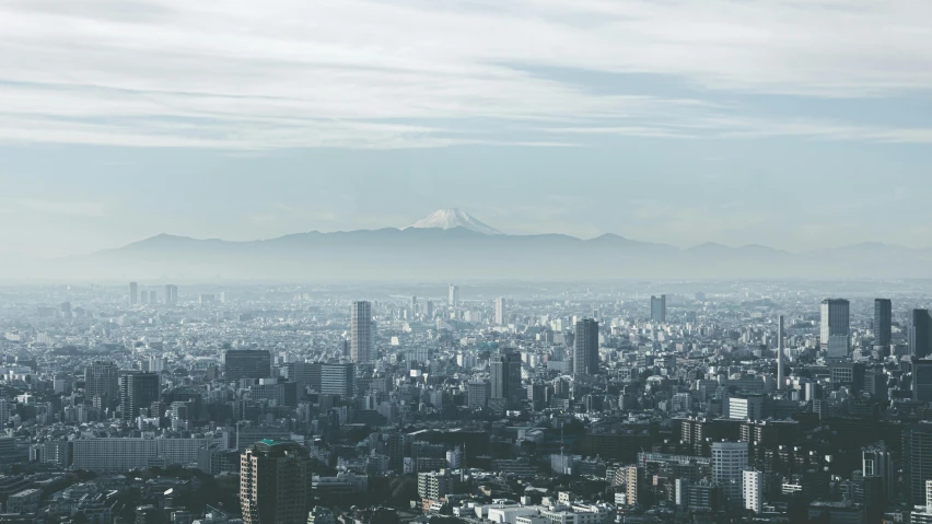 an aerial view of a city with mountains in the distance