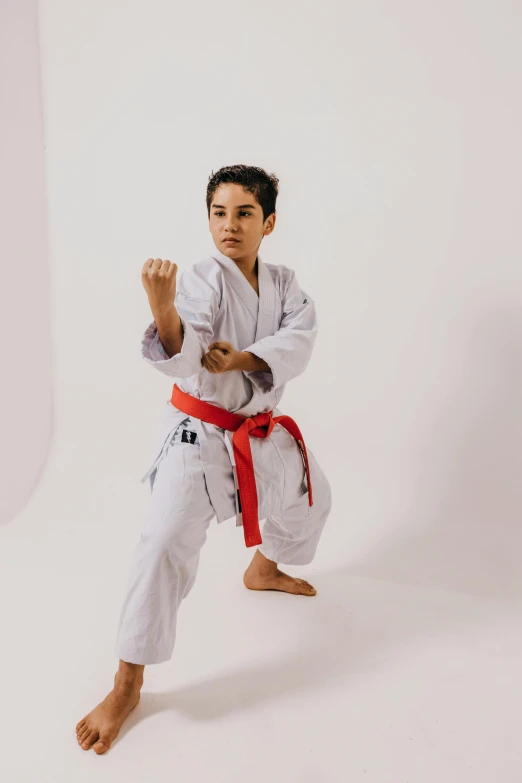 a young man practicing karate moves, in the studio