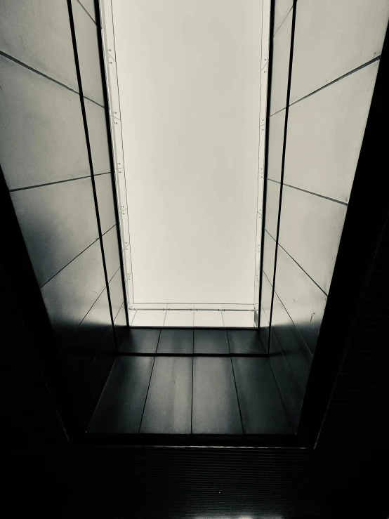 an empty hallway with a very high ceiling