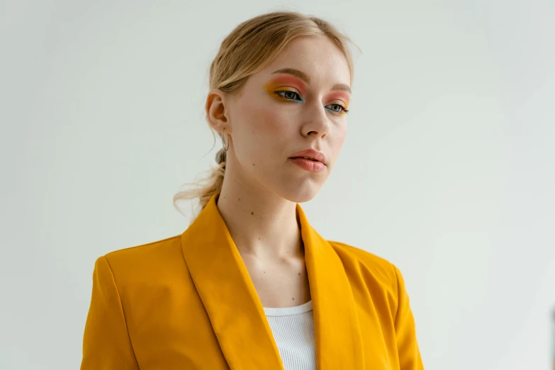 the woman has a yellow suit with an orange lip