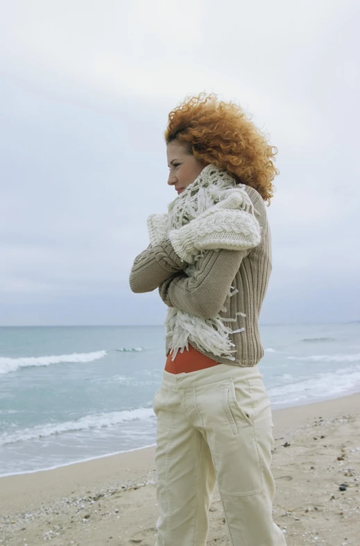 a woman on the beach talking on a phone