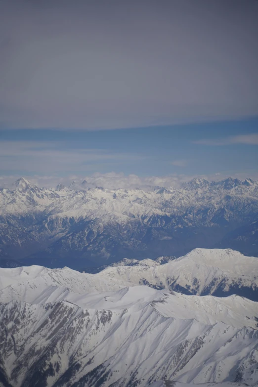 an airplane that is flying over the mountains