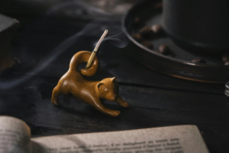 a miniature monkey figurine that is on top of a book