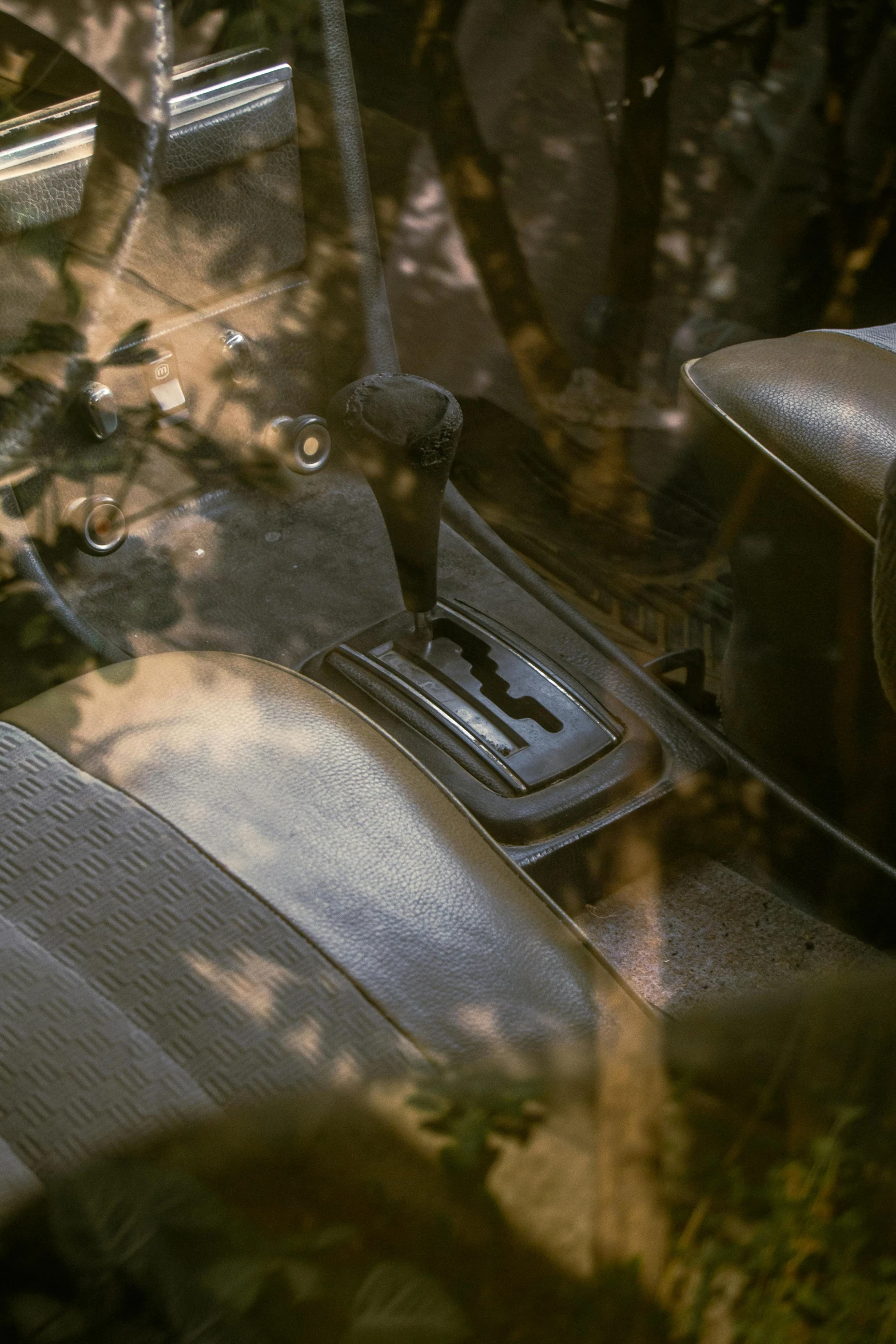 closeup of the dashboard, pedals, and passenger seat in a vintage car